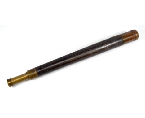 A brass 1.75" single-draw telescope with traces of inscription and stitched leather barrel, length 62.5cm.