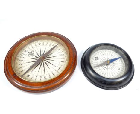 An early 19th century oak cased ship's compass and a similar smaller metal cased example with half blued hand, largest dial d