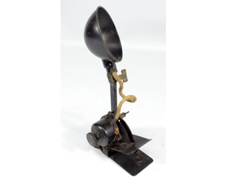 A WWII period pilot's clip on cockpit lamp, stamped 'AM' beneath a crown.