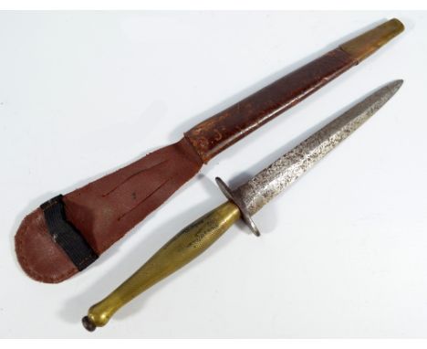 A Sykes Fairbairn type commando knife, with brass grip and shaped blade, in associated scabbard, length of blade 16cm. CONDIT