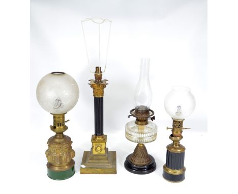 A brass moulded Gothic oil lamp with etched globular shade, a Corinthian column oil lamp, a late Victorian oil lamp with clea
