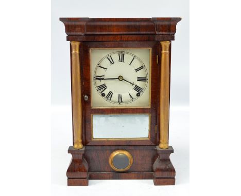 A late 19th century American rosewood mantel clock with associated dial set with Roman numerals and paper label inscribed 'Se