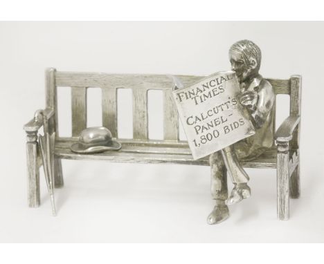 'Calcutts Panel, 1800 bids',by Sarah Jones, London 2000,a silver model of a gentleman sitting on a wooden bench, with hat and