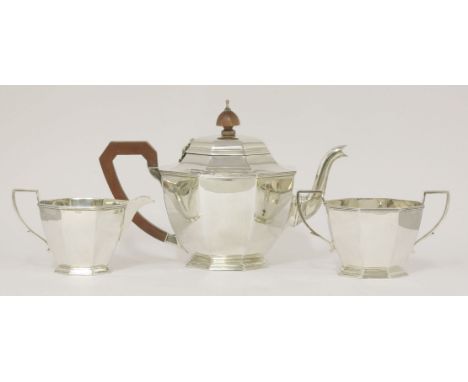 A silver three piece tea set,by Adie Bros Ltd., Birmingham 1941,of tapering octagonal form with reeded borders,the teapot 17c