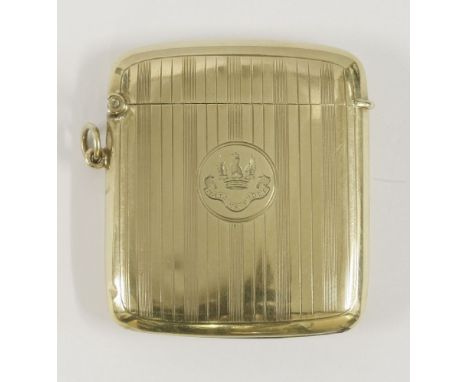 A gold vesta case,by Skinner & Co., London 1914,with linear engraving and crested with motto below,5.5cm long, with ring atta