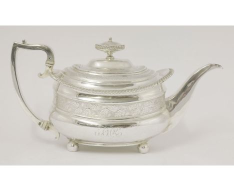 A George IV silver teapot,maker's mark unclear, London 1820,the handle with different maker's mark, of bellied oblong form wi