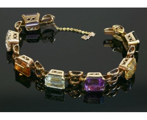 A gem set bracelet, c.1940,with a series of emerald cut gemstones to include citrine, amethyst, aquamarine, green tourmaline 