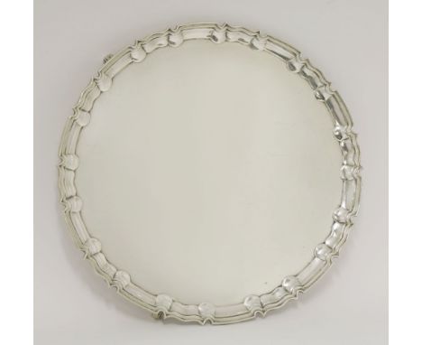 A late Victorian silver salver,by William Hutton and Sons Ltd., London 1895,of shaped circular form on three foliate scroll f