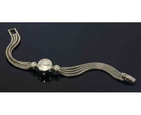 A ladies' 18ct white gold, diamond set, Omega mechanical cocktail watch,a circular silvered baton dial with safet glass, engi