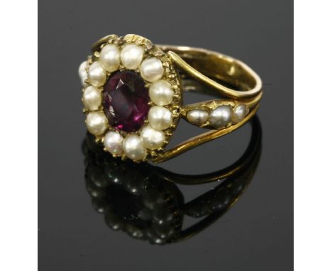 A Georgian gold foiled amethyst and split pearl ring,with an oval mixed cut foil back amethyst, grain set to a border of spli