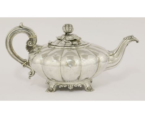 A George IV silver teapot,by Messrs Barnard, London 1829,of melon shape on four shell capped scroll feet, with melon finial, 