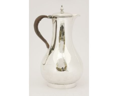 A George III silver hot water jug,probably by Philip Norman, London 1768,of baluster form, on collet foot, with leather clad 