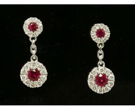 A pair of 18ct white gold, ruby and diamond drop earrings,composed of two graduated ruby and diamond cluster heads to post an
