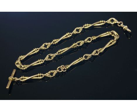 A Victorian gold Albert chain,with pairs of twisted bar links between knot links, with a 'T' bar to one end and swivel clip t