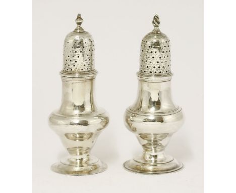 Two silver George III casters,one probably by Hester Bateman, London 1780,of baluster form on spreading circular foot, the pi