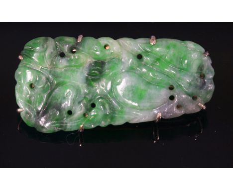 A carved jade plaque brooch, c.1930,depicting a gourd, claw set to a white gold frame, marked 9ct