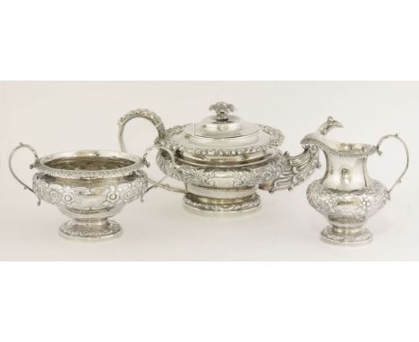 A George IV silver teapot,by Under Down Wilkinson & Co., Sheffield 1829,of compressed circular form on domed circular foot wi