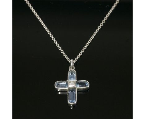 An 18ct white gold, aquamarine and diamond cross pendant,the Latin style cross with a princess cut diamond rub set to the cen