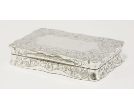 A Victorian silver snuff box,by William & Edward Turnpenny, Birmingham 1846,of shaped rectangular form, overall engraved with