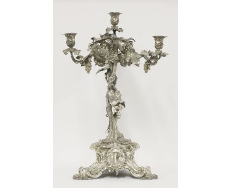 An early Victorian cast silver four-light candelabrum,by John Samuel Hunt, London 1846, resting on a foliate scrolling tripod