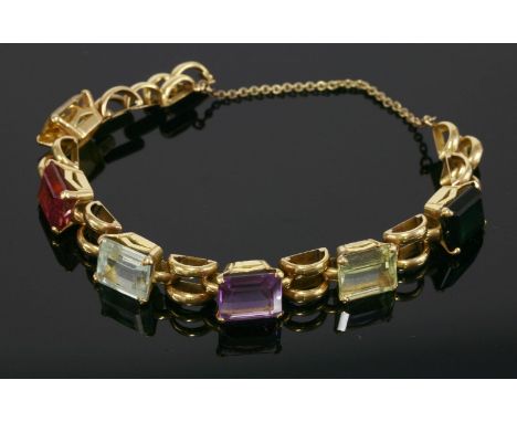 A gem set bracelet, c.1940,with a series of emerald cut gemstones to include citrine, pink tourmaline, aquamarine, amethyst, 