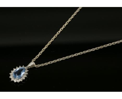 An 18ct white gold aquamarine and diamond cluster pendant,with a pear shaped aquamarine with a stated weight of 1.40ct, claw 