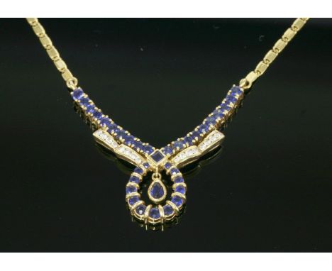 A gold, sapphire and diamond necklace,with a 'V' shaped looped centrepiece.  The centrepiece composed of a line of claw set s