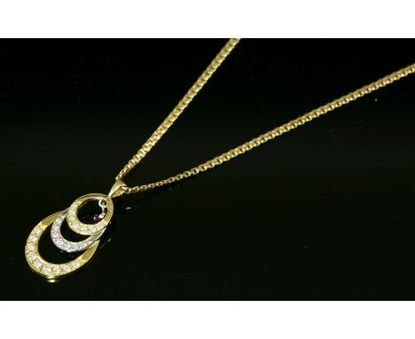 A yellow and white gold ruby and diamond set pendant,with three graduated alternating yellow and white gold oval hoops, grain
