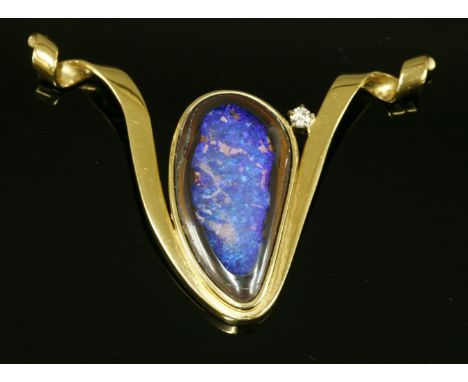 A gold, boulder opal and diamond slide pendant by Catherine Best,with a freeform boulder cabochon, rub set in a plain collet.
