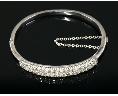 A late Victorian two row diamond set bangle,with two rows of graduated old Swiss cut and eight cut diamonds, claw set to the 