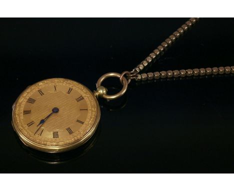 A gold, key wound Swiss fob watch,suspended on a gold guard chain.  The fob watch 37mm diameter with a gold dial, black Roman