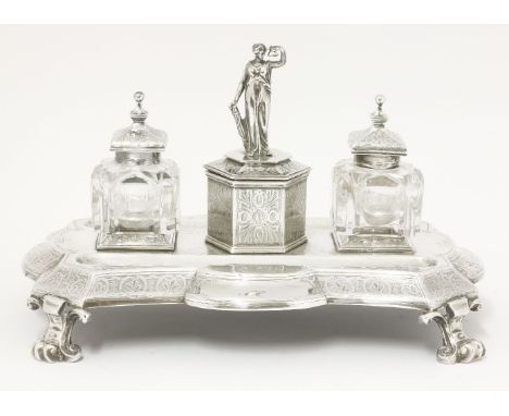 A Victorian silver inkstand, by Edward & John Barnard, London 1865,of shaped rectangular form on pierced stylised scroll feet