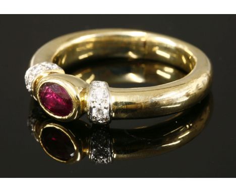 An Italian gold, ruby and diamond ring,with an oval mixed cut ruby rub set in a landscape position.  Arched shoulders, each g