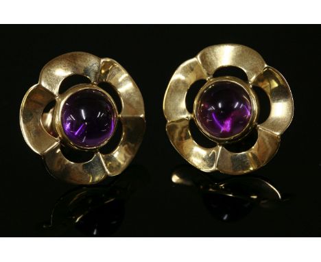 A pair of 9ct gold cabochon amethyst earrings,with a circular cabochon amethyst rub set to the centre with a flat scalloped o
