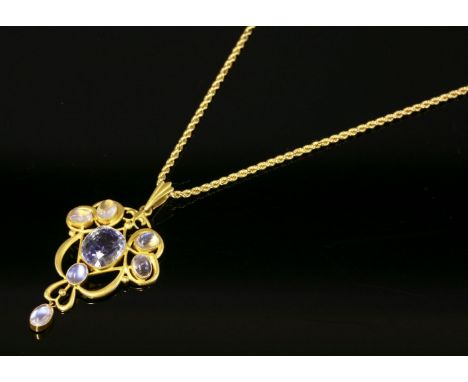 An Edwardian gold, sapphire and moonstone pendant, c.1905,with an oval native cut sapphire, milligrain set to the centre.  A 