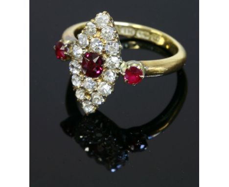 A late Victorian ruby and diamond marquise shaped cluster ring,Birmingham 1894.  A central oval Swiss cut ruby, surrounded by