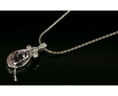 An 18ct white gold kunzite and diamond pendant,with a pear shaped kunzite rub set to a plain collet with a trefoil cluster of