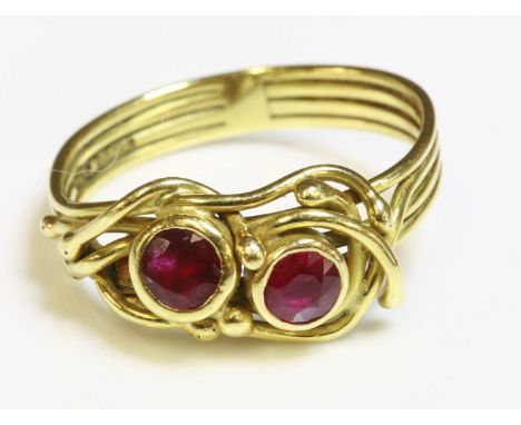 An 18ct gold two stone ruby ring by Susan Wright,with two circular mixed cut rubies rub set in individual collets.  A looped 