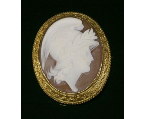 A late Victorian carved shell cameo brooch,depicting the profile of Mercury in white to a light tan ground.  The cameo rub se