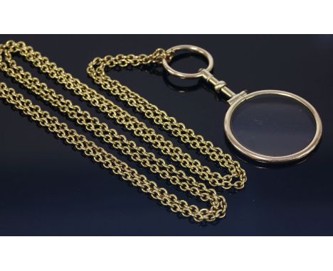 A Georgian gold cased quizzing glass,suspended on a trace link guard chain marked 15ct.  Later 9ct gold jump ring to one end