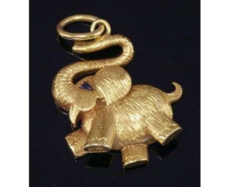 An 18ct gold novelty elephant pendant by Cartier, c.1975,the lucky elephant with its trunk held aloft, a triangular cabochon 