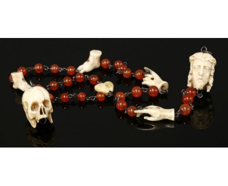 An antique cornelian and carved ivory incomplete rosary,with carved skull, head of Christ, heart, hands and feet depicting st