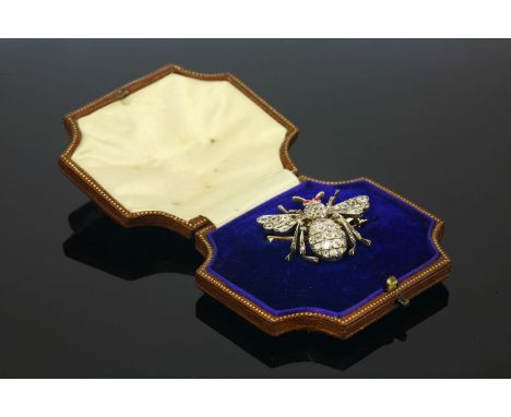 A cased late Victorian diamond and ruby bee brooch, c.1890,the bee with a cluster of cushion shaped old Swiss cut diamonds fo
