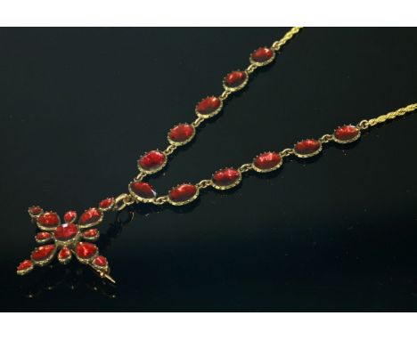 A late 18th century garnet set rivière,with a garnet set cruciform brooch/pendant.  The rivière composed of a series of oval,