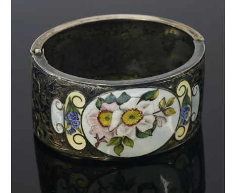 A Victorian silver, hand engraved hinged cuff bangle,with a polychrome enamel panel depicting a dog rose to a light blue grou
