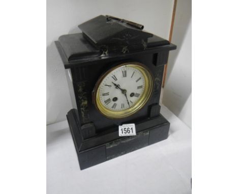 A black slate mantel clock with key and pendulum
