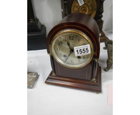 A domed top inlaid mantel clock in working order