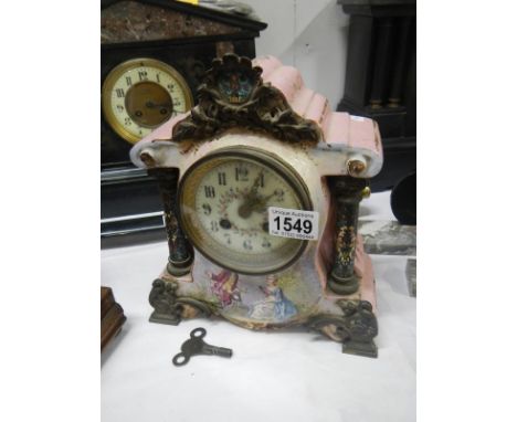 A Victorian porcelain mantel clock with cloissonne pillars