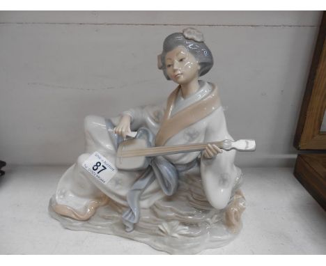 A large Nao Geisha girl playing a stringed instrument A/F