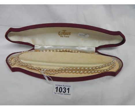 A cased pearl necklace